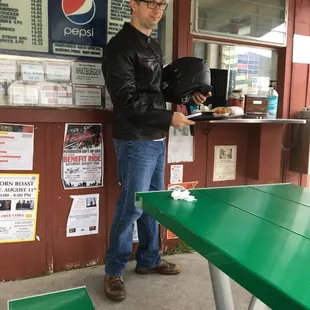 a man standing at a green table