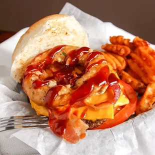 Freshly grilled cheeseburger with onion ring and bbq sauce
