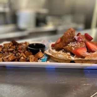 a plate of waffles and strawberries