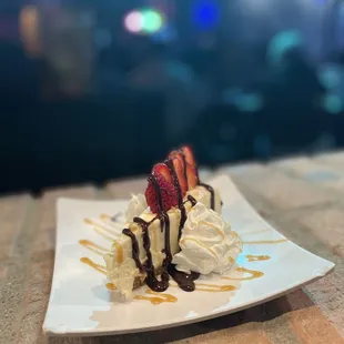 a desert with whipped cream and strawberries