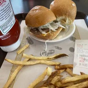 a plate of french fries and a bottle of ketchup