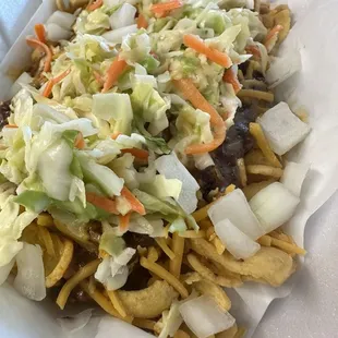 Frito chili pie with slaw and onions
