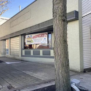 a large tree in front of a restaurant