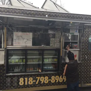 a man ordering food from a food truck