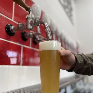 a beer being poured into a glass