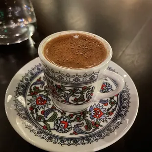 Turkish coffee, strong with no cardamom flavor and 1/5th grounds