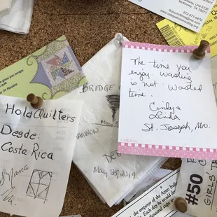 a corked cork board covered in notes