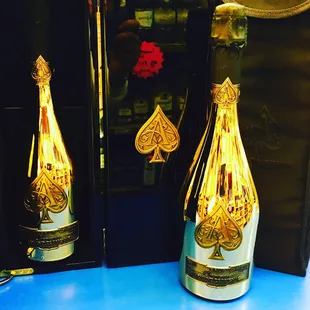 a bottle of champagne with playing cards on it