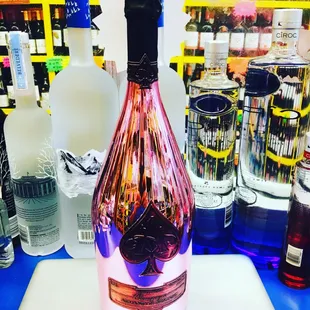 a bottle of pink wine on a counter