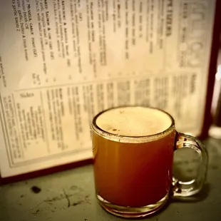 a glass of beer and a menu