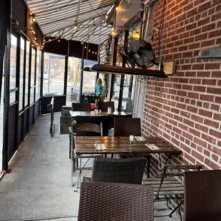 a patio with tables and chairs