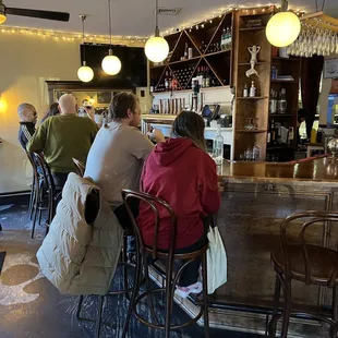 a group of people sitting at a bar