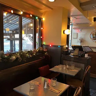 a view of a dining room with christmas lights