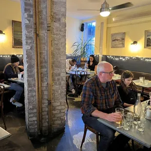 people sitting at tables in a restaurant