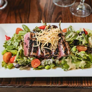 a plate of salad with meat and vegetables