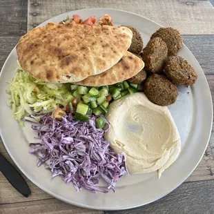 a plate of food on a wooden table