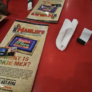 a table with a menu and napkins