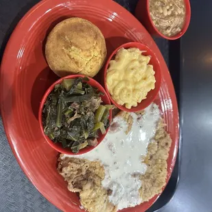 Chicken fried steak with country pepper gravy, Mac n cheese, collard greens, black eyed peas, and corn bread