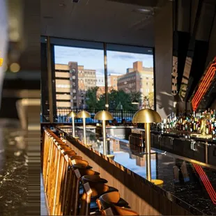 a bartender holding a drink at a bar