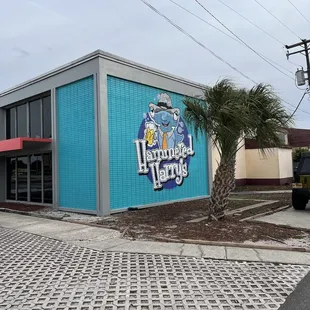 a blue building with a sign on it