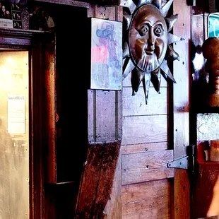 a bar with a sun face on the wall