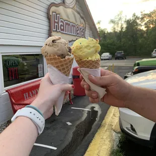 two people holding ice cream cones