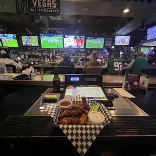 a view of the bar and televisions