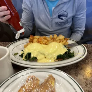 a woman sitting at a table with a plate of food