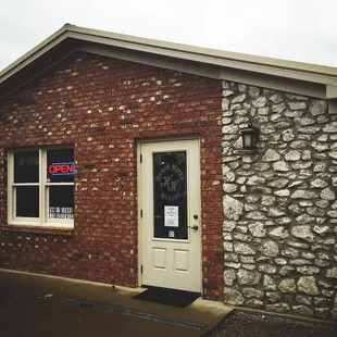 a brick building with a for sale sign