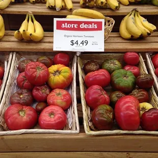 a display of tomatoes and bananas
