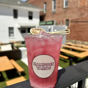 a pink drink in a plastic cup
