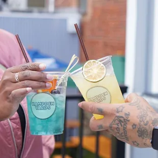 a man handing a drink to a woman