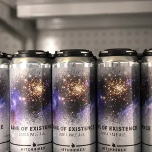 six cans of beer on a shelf