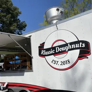 a man standing in front of a food truck
