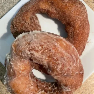 two glazed donuts on a plate