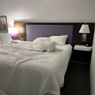 A bed that clearly someone has laid in.