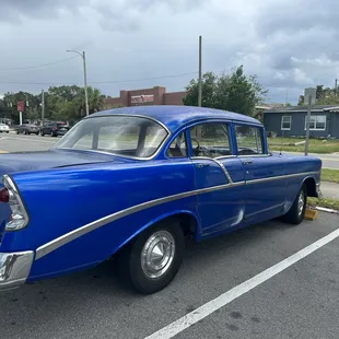 a classic american car parked in a parking lot