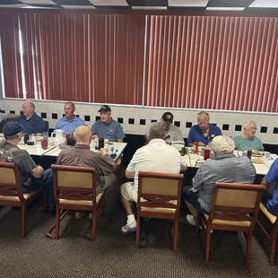 a group of people sitting at a table
