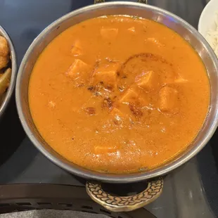 a bowl of curry and a bowl of rice