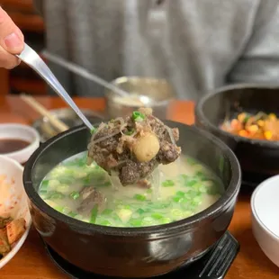 a person eating a bowl of soup