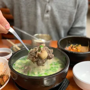 a person eating a bowl of soup