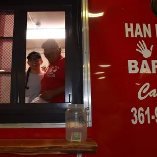 a man and a woman looking out a window