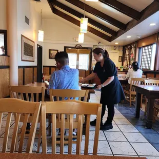 a waitress serving customers in a restaurant