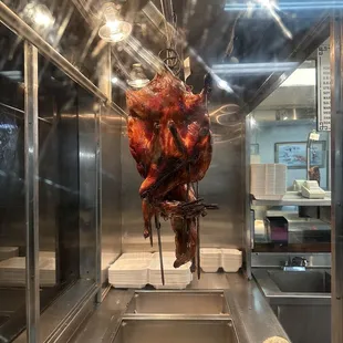 a ham hanging in a commercial kitchen