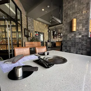 Exterior patio with double leaf glass entrance doors on the left and the bar in the background.