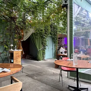 a patio with tables and chairs