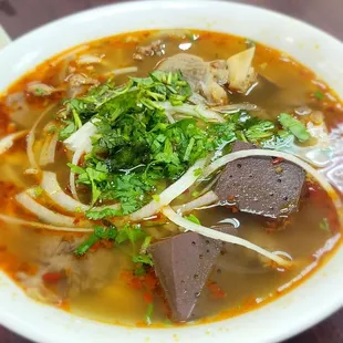 Trying their bún bò Huế. It was ok, little bit salty.