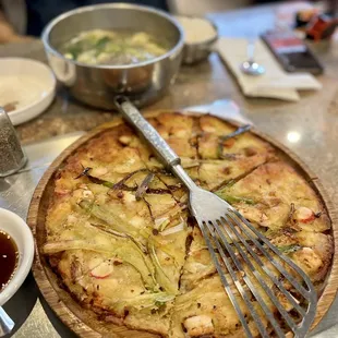 a pizza with a fork and knife