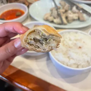 a person holding a piece of food