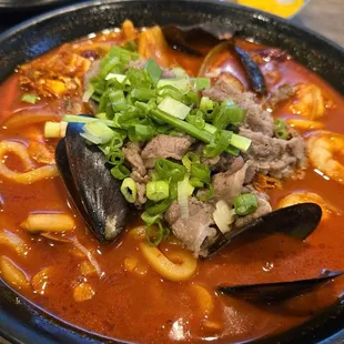 Chinese seafood spicy noodle soup with beef. I am a chef myself, but I can&apos;t tell what makes the soup taste so different than others.